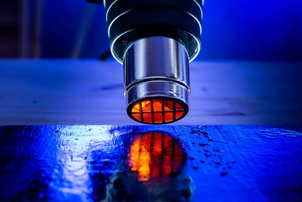 close up of a heat gun with the heating element glowing orange