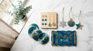 A bright, clean flat-lay of assorted beginner resin gifts — round resin coasters with gold flecks, resin pendants and stud earrings, resin Christmas ornaments, and a small marbled resin tray — arranged on white marble near a sunlit window.